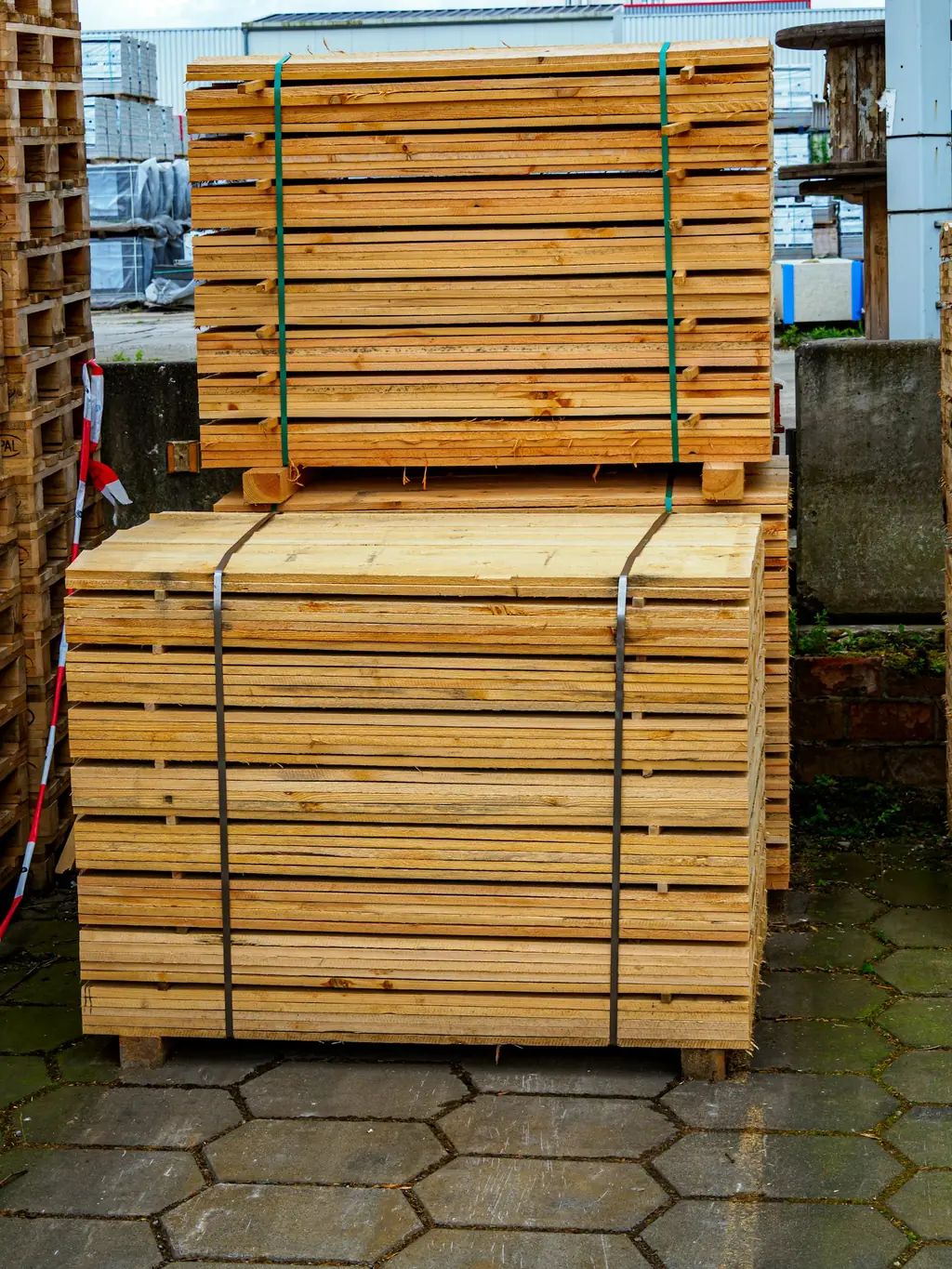 Bundles of sawn pine timber planks stacked at a timber yard