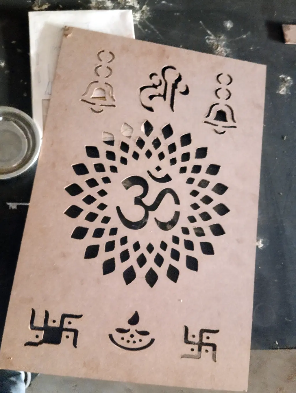 CNC cut jaali panel with Om, bells, diya and swastik motifs