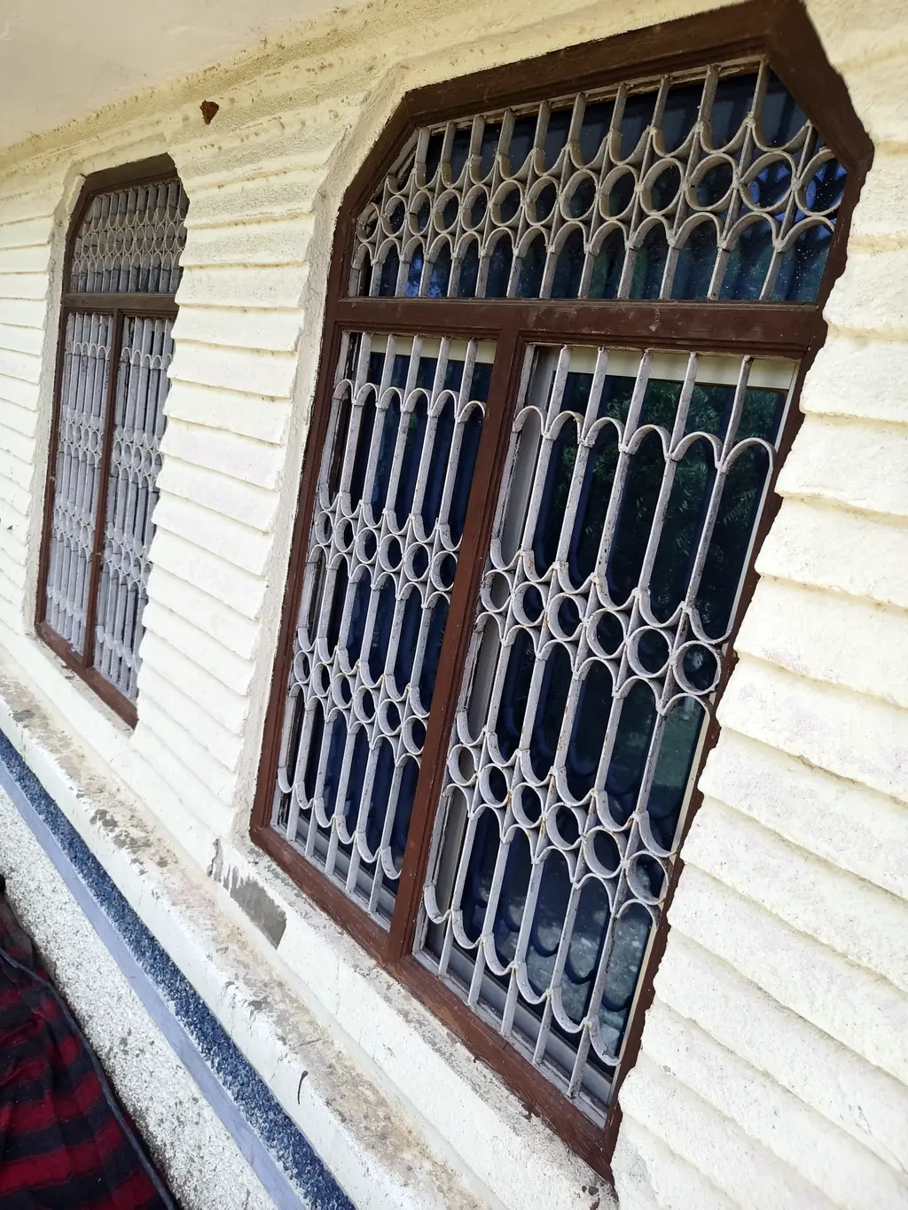 Wooden window frames with decorative grills fitted in a house